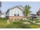Charming single-story home with a brick foundation, a well-manicured lawn, and a cozy front porch at 360 Lincoln W Cir, Fortville, IN 46040