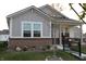 Charming single-story home featuring stylish gray siding, a brick foundation, and a cozy front porch at 360 Lincoln W Cir, Fortville, IN 46040