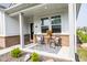 Cozy front porch with seating area, a decorative rug, and a charming view of the neighborhood at 360 Lincoln W Cir, Fortville, IN 46040