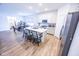 Open concept kitchen with a large island, stainless steel appliances, and modern finishes overlooking dining area at 360 Lincoln W Cir, Fortville, IN 46040