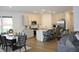 A kitchen and dining area features stainless steel appliances and a large island with seating at 360 Lincoln W Cir, Fortville, IN 46040