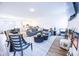 Open-concept living room showcasing a gray sectional sofa, round coffee tables, and a view into the dining area at 360 Lincoln W Cir, Fortville, IN 46040