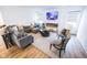 Bright living room featuring a cozy gray sectional sofa and a modern fireplace with a flatscreen TV above at 360 Lincoln W Cir, Fortville, IN 46040