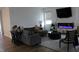 Cozy living room with a comfortable gray sofa, area rug, and modern electric fireplace at 360 Lincoln W Cir, Fortville, IN 46040