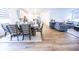 Open concept kitchen and dining area flowing into a living room with a gray sectional sofa at 360 Lincoln W Cir, Fortville, IN 46040