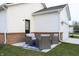 Private outdoor patio featuring stylish furniture, a brick foundation, and a convenient access door to the house at 360 Lincoln W Cir, Fortville, IN 46040