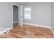 Cozy bedroom featuring hardwood floors, gray walls, a closet, and a window at 3758 Broadway St, Indianapolis, IN 46205