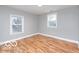This bedroom is painted a neutral color and has gleaming hardwood floors at 3758 Broadway St, Indianapolis, IN 46205