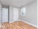 This bedroom features hardwood floors, neutral paint, a window and two closets at 3758 Broadway St, Indianapolis, IN 46205