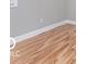 Detail of hardwood floors and white trim in a bedroom with neutral gray walls at 3758 Broadway St, Indianapolis, IN 46205