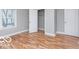 Cozy bedroom with hardwood floors, neutral gray walls, closet, and a window at 3758 Broadway St, Indianapolis, IN 46205