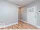 Bright entryway featuring a glass-paneled door and beautiful wood-look laminate flooring at 3758 Broadway St, Indianapolis, IN 46205