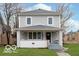 Charming two-story home with a covered front porch and freshly painted siding at 3758 Broadway St, Indianapolis, IN 46205
