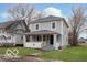 Charming two-story home with a covered front porch and freshly painted siding at 3758 Broadway St, Indianapolis, IN 46205