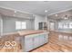 Open kitchen featuring a butcher block island, stainless steel appliances, and light gray cabinetry at 3758 Broadway St, Indianapolis, IN 46205