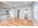 Bright living room featuring hardwood floors, neutral gray walls, and access to the kitchen and bathroom at 3758 Broadway St, Indianapolis, IN 46205
