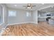 Open-concept living area with laminate floors and views of the modern kitchen at 3758 Broadway St, Indianapolis, IN 46205