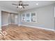 Bright living room with laminate floors and a ceiling fan at 3758 Broadway St, Indianapolis, IN 46205