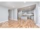 Spacious living room with hardwood floors, neutral gray walls, and open layout to the kitchen at 3758 Broadway St, Indianapolis, IN 46205