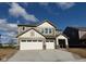 Two-story home featuring a two car garage, stone accents, neutral siding and a concrete driveway at 3867 Andean Ct, Bargersville, IN 46106
