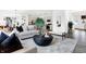 Stylish living area with open design to the kitchen, modern furnishings, and hardwood floors at 3867 Andean Ct, Bargersville, IN 46106