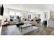 Bright living room with modern furnishings, wood floors, and an open floor plan to the dining area at 3867 Andean Ct, Bargersville, IN 46106
