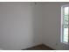 Bright bedroom featuring hardwood floors, white walls, and a window for natural light at 4234 Kingsley Dr, Indianapolis, IN 46205