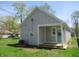 Exterior view of home with grass lawn and side entrance at 4234 Kingsley Dr, Indianapolis, IN 46205