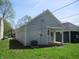 Exterior view of home with grass lawn and side entrance at 4234 Kingsley Dr, Indianapolis, IN 46205