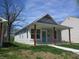 Charming home featuring a cozy front porch with red wood pillars and light blue front door at 4234 Kingsley Dr, Indianapolis, IN 46205