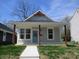 Charming home featuring a cozy front porch with red wood pillars and light blue front door at 4234 Kingsley Dr, Indianapolis, IN 46205