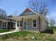 Charming home featuring a cozy front porch with red wood pillars and light blue front door at 4234 Kingsley Dr, Indianapolis, IN 46205