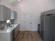 Modern kitchen with stainless steel appliances, granite countertops, grey cabinets, and patterned backsplash at 4234 Kingsley Dr, Indianapolis, IN 46205