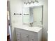Bathroom with a white vanity, marble countertop, silver faucet, and updated lighting at 436 Tavistock Dr, Mooresville, IN 46158