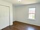 Bedroom featuring hardwood flooring, natural light from a window, and closet space at 436 Tavistock Dr, Mooresville, IN 46158