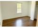 Bedroom with window, hardwood floors, neutral walls, and ample closet space at 436 Tavistock Dr, Mooresville, IN 46158