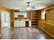 Spacious living room features knotty pine walls, built-in shelving and white cabinets with new countertop and backsplash at 436 Tavistock Dr, Mooresville, IN 46158