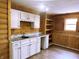 Spacious living room features knotty pine walls, built-in shelving and white cabinets with new countertop and backsplash at 436 Tavistock Dr, Mooresville, IN 46158
