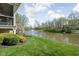 Landscaped backyard featuring a pond with a fountain and green lawn at 4557 Marigold Ct, Greenwood, IN 46143