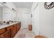 Bathroom with granite countertops, wood cabinets, and a sink, combining style and functionality at 4557 Marigold Ct, Greenwood, IN 46143