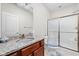 Bathroom featuring granite countertop, wood cabinets, and a shower with glass doors at 4557 Marigold Ct, Greenwood, IN 46143