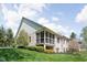 Brick home featuring a screened-in porch and well-maintained landscaping at 4557 Marigold Ct, Greenwood, IN 46143