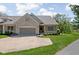 Charming brick home with a two-car garage and beautifully landscaped front yard at 4557 Marigold Ct, Greenwood, IN 46143