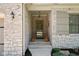 Inviting front porch with brick accents, stylish lighting, and decorative plants at 4557 Marigold Ct, Greenwood, IN 46143