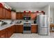 Functional kitchen with wood cabinetry, stainless steel appliances, and ample counter space at 4557 Marigold Ct, Greenwood, IN 46143