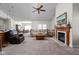 Spacious living room with a fireplace, carpet flooring, and an open layout to the dining area at 4557 Marigold Ct, Greenwood, IN 46143
