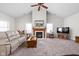 Comfortable living room with a fireplace, vaulted ceilings, and large windows for ample natural light at 4557 Marigold Ct, Greenwood, IN 46143