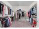 Spacious walk-in closet with carpet and ample shelving, providing plenty of storage for an organized wardrobe at 4557 Marigold Ct, Greenwood, IN 46143
