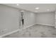 Open finished basement boasts neutral paint, recessed lighting, and durable gray marble-look tile floor at 4775 E 56Th St, Indianapolis, IN 46220