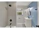 Bathroom featuring updated vanity, fixtures, and tiled shower and bath at 4775 E 56Th St, Indianapolis, IN 46220